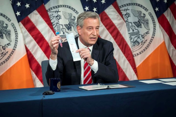 New York City Mayor Bill de Blasio holds a 3D printed nasopharyngeal swab
